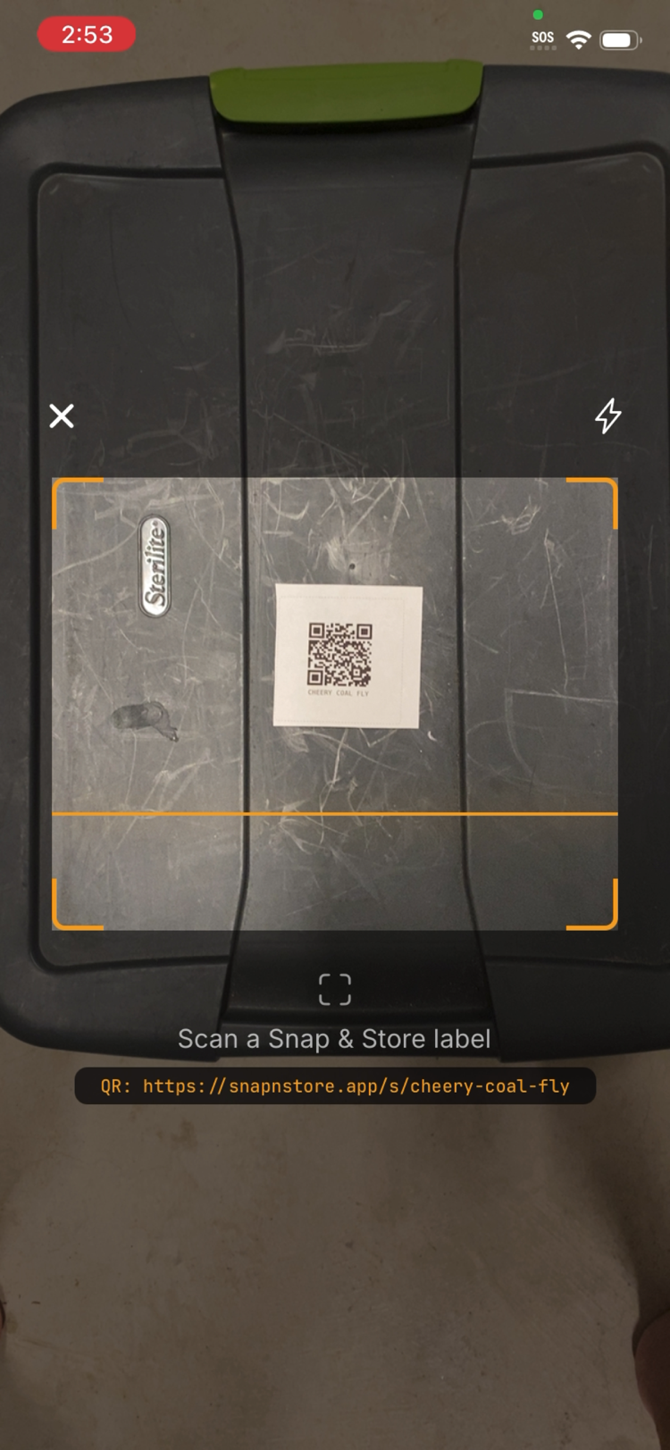 Scanning a box's QR label with Snap & Store to see its contents without opening it